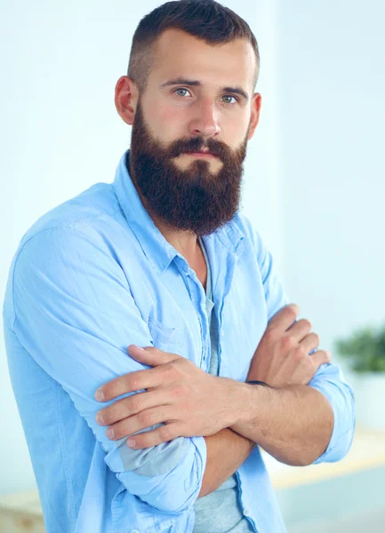 Portrait of male designer in hat with blueprints at desk — Stock Photo, Image