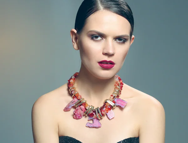 Portrait of young beautiful brunette woman in beads — Stock Photo, Image