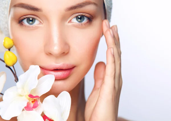 Portrait of beautiful girl touching her face with a towel on her head — Stock Photo, Image