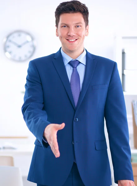 Business and office concept - handsome businessman with open hand ready for handshake — Stock Photo, Image