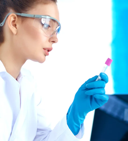 Woman researcher is surrounded by medical vials and flasks, isolated on white background — Stock Photo, Image