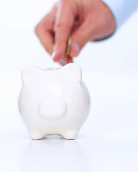 Putting coin into the piggy bank — Stock Photo, Image