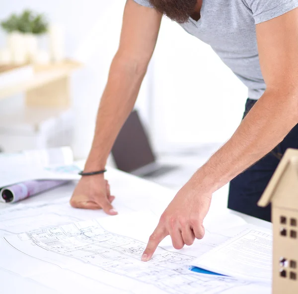 Portrait of male designer in hat with blueprints at desk — Stock Photo, Image