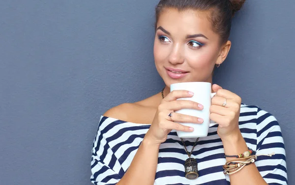 Portrait of young woman with cup tea or coffee — Stock Photo, Image