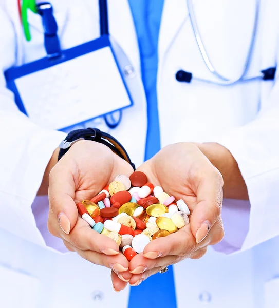 Doctor holding heap of drugs in a hand — Stock Photo, Image
