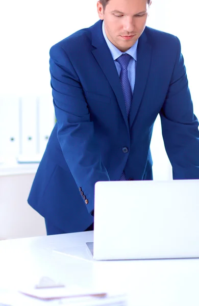 Vertrouwen succesvolle jonge zakenman leunend wapens op zijn Bureau — Stockfoto