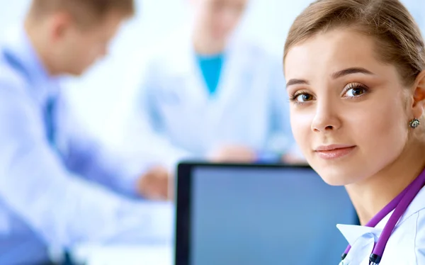 Medical team sitting at the table in modern hospital — Stock Photo, Image