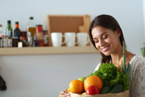 Young woman holding grocery shopping bag with vegetables — Stock Photo, Image