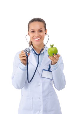 Doktor kadın elmayı steteskopla inceliyor.