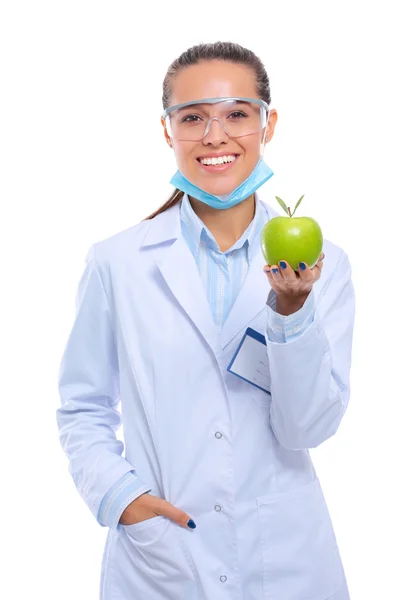 Mosolygó nő orvos egy zöld alma. — Stock Fotó