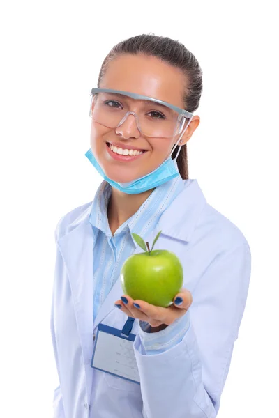 Mulher sorridente médico com uma maçã verde. — Fotografia de Stock