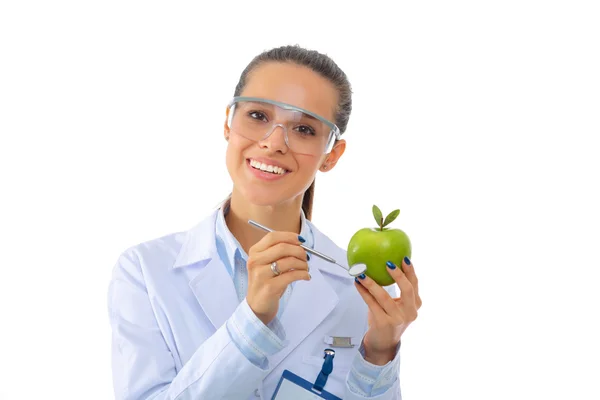 Mulher sorridente médico com uma maçã verde. — Fotografia de Stock