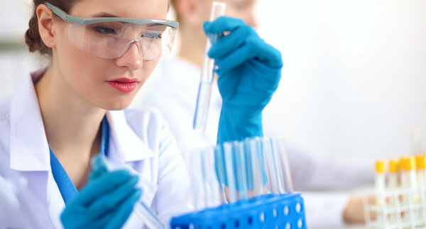 Woman researcher is surrounded by medical vials and flasks, isolated on white background