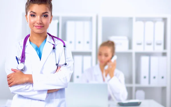 Portrait of young woman doctor with white coat standing in hospital — Stock Photo, Image