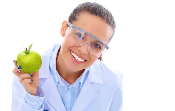 Mosolygó nő orvos egy zöld alma. — Stock Fotó
