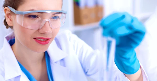 Woman researcher is surrounded by medical vials and flasks, isolated on white background — Stock Photo, Image