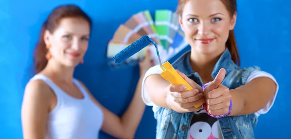 Two Beautiful young woman doing wall painting — Stock Photo, Image