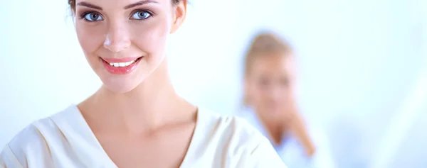 Attractive businesswoman standing near wall in office — Stock Photo, Image