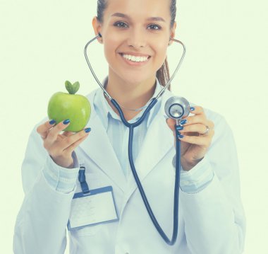 Medical doctor woman examining apple with stethoscope clipart