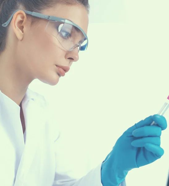 Woman researcher is surrounded by medical vials and flasks, isolated on white background — Stock Photo, Image