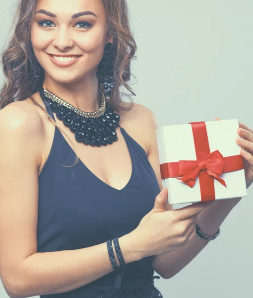 Young woman happy smile hold gift box in hands, isolated over grey background