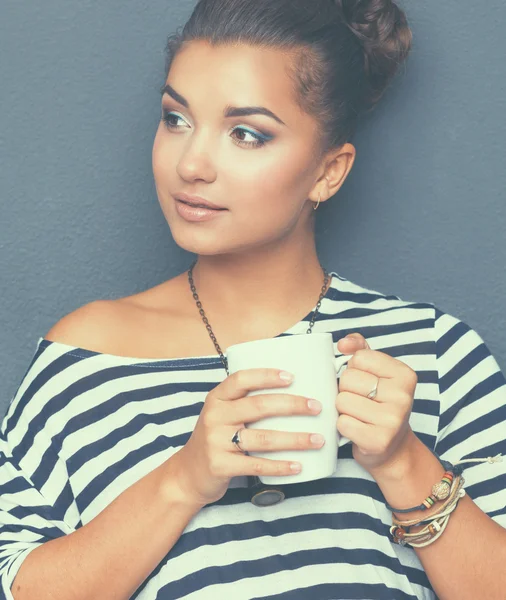 Portrait of young woman with cup tea or coffee — Stock Photo, Image