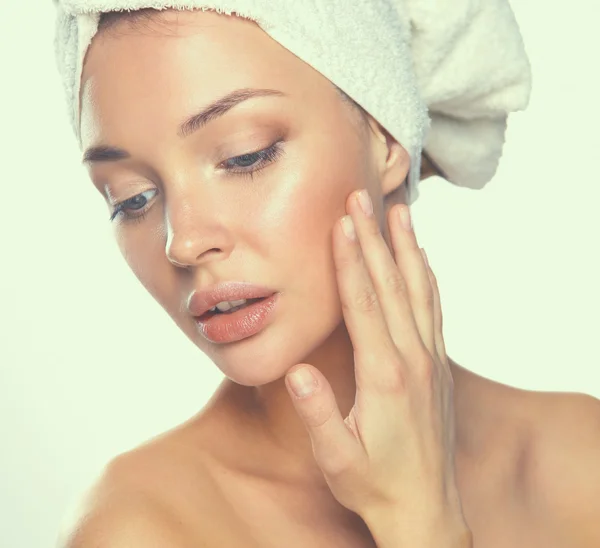 Portrait of beautiful girl touching her face with a towel on  head — Stock Photo, Image