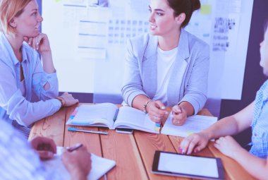Masada kitaplarla çalışan gençler. Güzel kadınlar ve erkekler birlikte çalışıyor..