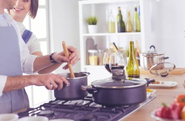 Evdeki mutfakta birlikte yemek pişiren çift.