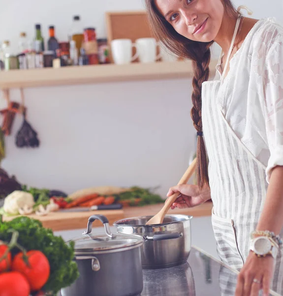 Cooking woman in kitchen with wooden spoon. Cooking woman — Stock Photo, Image