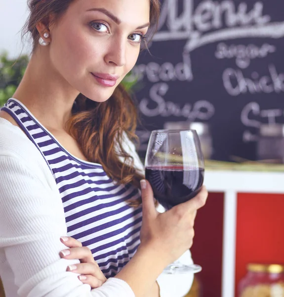 Hezká žena pije nějaké víno doma v kuchyni — Stock fotografie