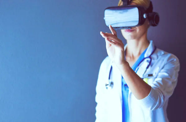 Female doctor wearing virtual reality glasses isolated on white background.