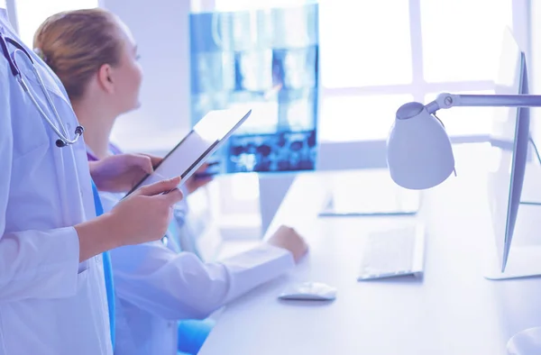 Крупним планом знімок лікаря з планшетом і колегою з рентгенівським випромінюванням на фоні . — стокове фото