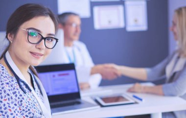 Doktor ve hasta masada otururken bir şey tartışıyorlar. İlaç ve sağlık hizmetleri kavramı