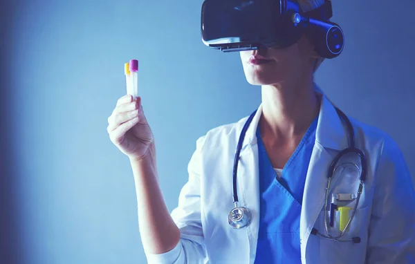 Female doctor wearing virtual reality glasses isolated on white background.