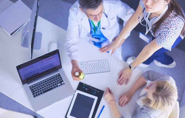 Doctor and patient discussing something while sitting at the table . Medicine and health care concept — Stock Photo, Image