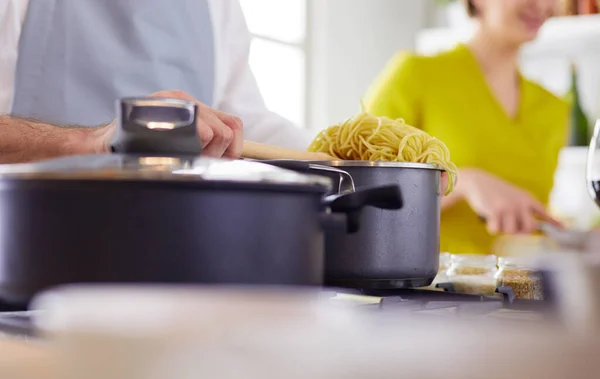 Couple cooking together in the kitchen at home — Stock Photo, Image