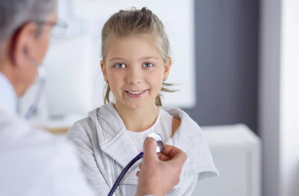 Girl and doctor with stethoscope listening to heartbeat — Stock Photo, Image