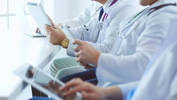 Medical team sitting and discussing at table — Stock Photo, Image