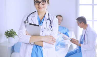 Hastane lobisinde tablet bilgisayar kullanan kadın doktor.