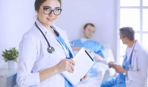 Female doctor using tablet computer in hospital lobby