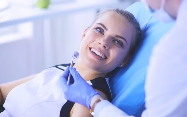 Joven paciente femenina con sonrisa bonita examinando la inspección dental en el consultorio del dentista. — Foto de Stock