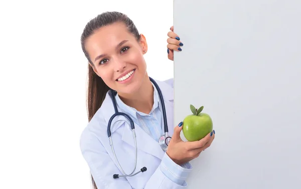 Smiling doctor with apple and blank banner — Stock Photo, Image