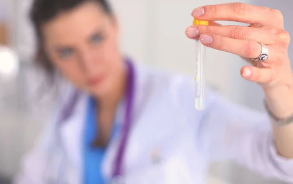 Woman researcher is surrounded by medical vials and flasks, isolated on white background — Stock Photo, Image