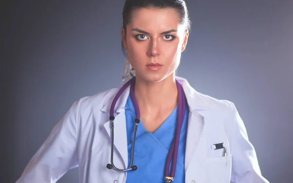 Young doctor woman with stethoscope isolated on grey — Stock Photo, Image