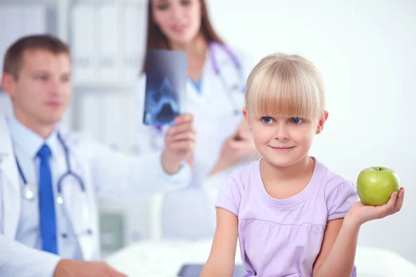 Child and medicine concept - female doctor giving an apple to little girl — Stock Photo, Image