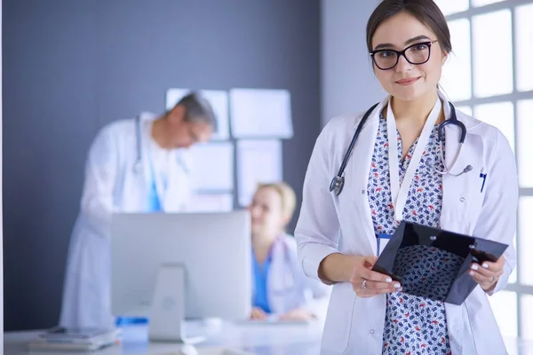 Female doctor using tablet computer in hospital lobby