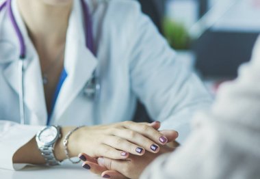 Kadın doktor yaşlılara hastanede el ele tutuşmalarında yardım ediyor