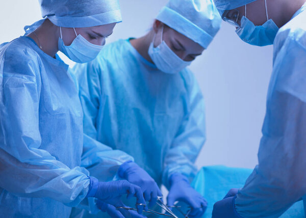 Team surgeon at work in operating room.