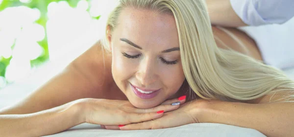 Розслаблена жінка отримує масаж спини в спа-центрі — стокове фото